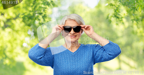 Image of smiling senior woman in black sunglasses