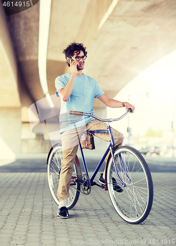 Image of man with smartphone and fixed gear bike on street