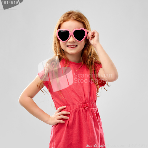 Image of smiling red haired girl in heart shaped sunglasses