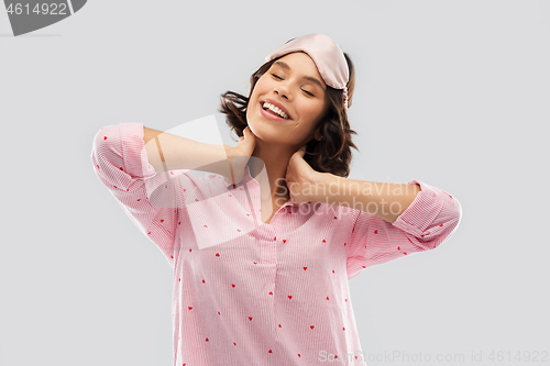 Image of happy young woman in pajama and eye sleeping mask