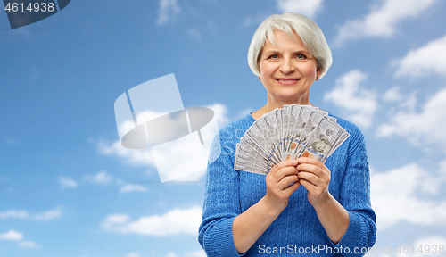 Image of senior woman with hundred dollar money banknotes