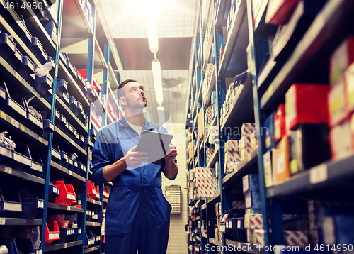 Image of auto mechanic or smith with tablet pc at workshop