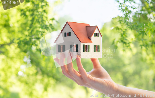 Image of close up of hand holding house or home model