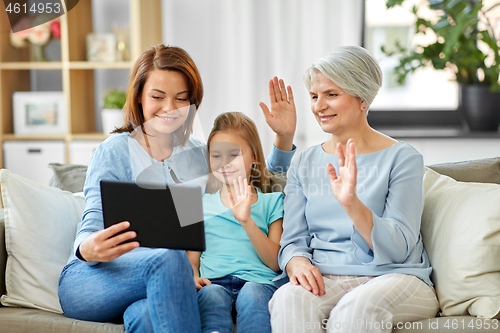 Image of mother, daughter and grandmother with tablet pc