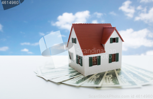 Image of close up of home or house model and money