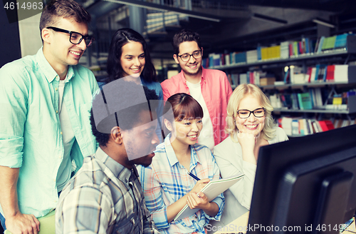 Image of international students with computers at library