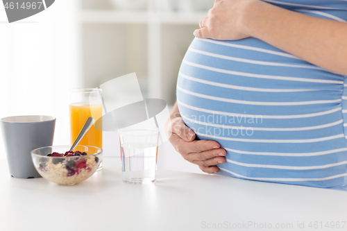 Image of close up of pregnant woman touching her belly