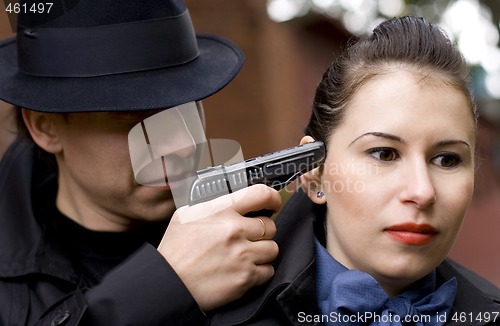 Image of man threatens the woman with gun