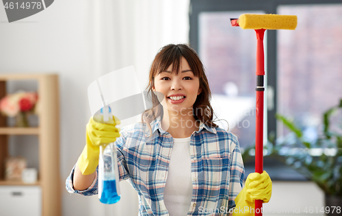 Image of asian woman with window detergent and sponge mop