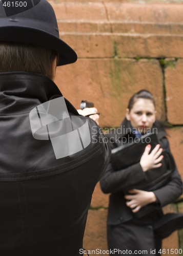 Image of man threatens the woman with gun