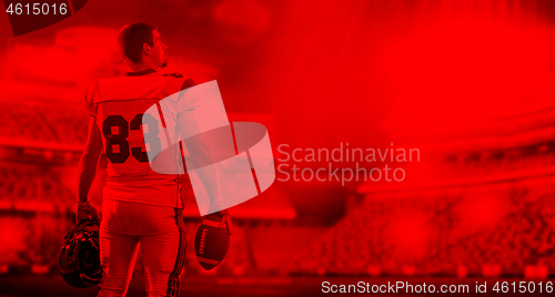 Image of duo toned american football player in  arena at night