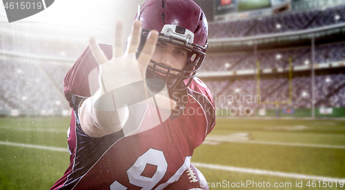 Image of portrait of confident American football player