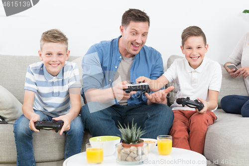 Image of Happy young family playing videogame On TV.