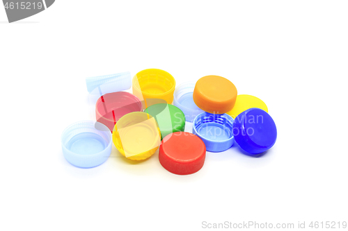 Image of Multicolored caps from plastic bottles on white background