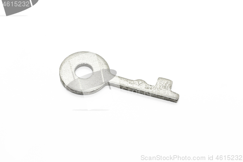 Image of Simple metallic key on white background