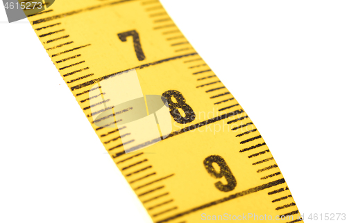 Image of Close-up of a yellow measuring tape isolated on white - 8