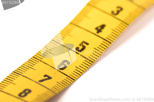 Image of Close-up of a yellow measuring tape isolated on white - 6