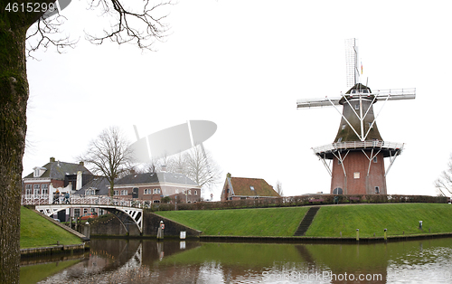 Image of Dokkum, the Netherlands on December 26, 2019: Canal and windmill