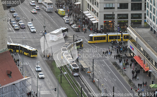 Image of BERLIN, GERMANY on December 31, 2019: People pass tram ways in t