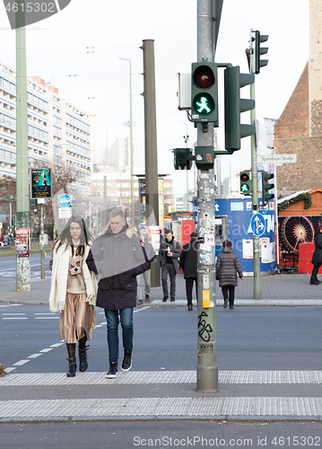 Image of BERLIN, GERMANY - Januari 1, 2020: People stand on a pedestrian 