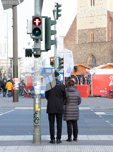 Image of BERLIN, GERMANY - Januari 1, 2020: People stand on a pedestrian 