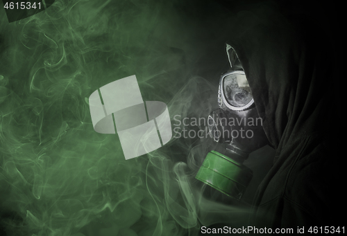 Image of Man in a gas mask in the toxic smoke