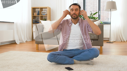Image of man in headphones chilling at home
