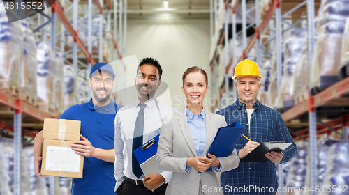 Image of group of business people and warehouse workers