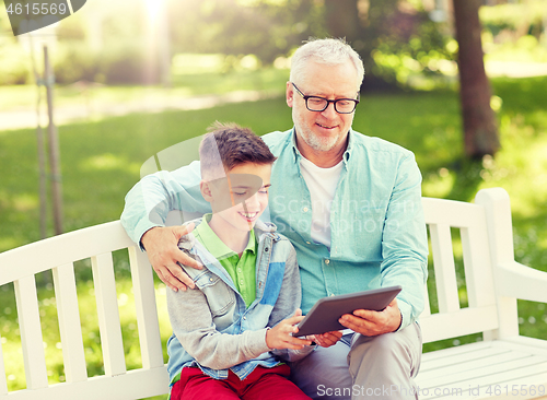 Image of grandfather and boy with tablet pc at summer park