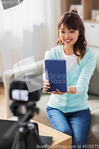 Image of asian female blogger making video review of book