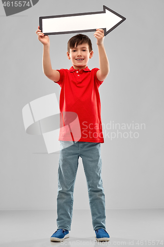 Image of boy holding big white rightwards thick arrow