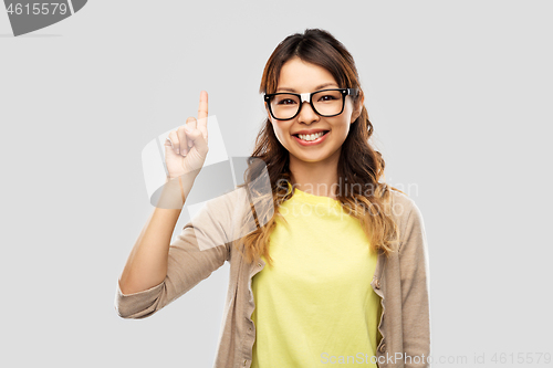 Image of asian woman in glasses or student with finger up