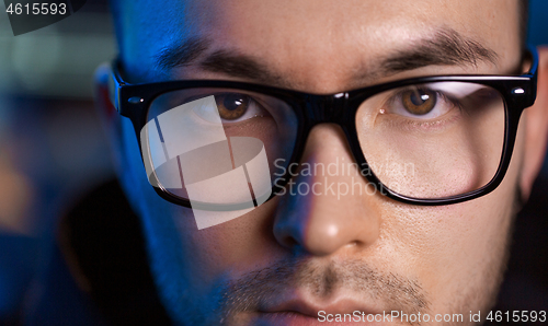 Image of close up of asian male hacker\'s face in glasses