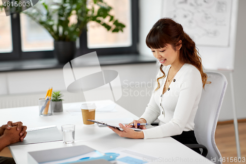 Image of employer having interview with employee at office