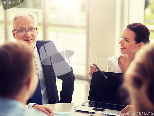 Image of business people with laptop meeting in office