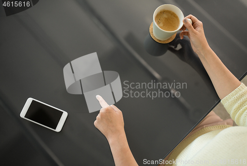 Image of woman with coffee using black interactive panel