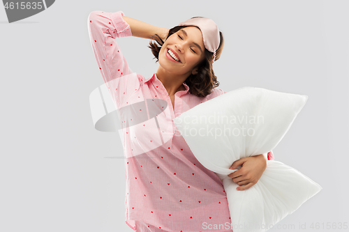 Image of woman with pillow in pajama and eye sleeping mask