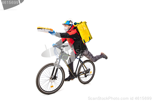 Image of Too much orders. Contacless delivery service during quarantine. Man delivers food and shopping bags during isolation, wearing gloves and face mask.