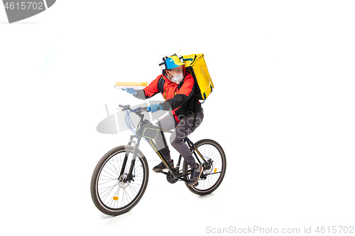 Image of Too much orders. Contacless delivery service during quarantine. Man delivers food and shopping bags during isolation, wearing gloves and face mask.