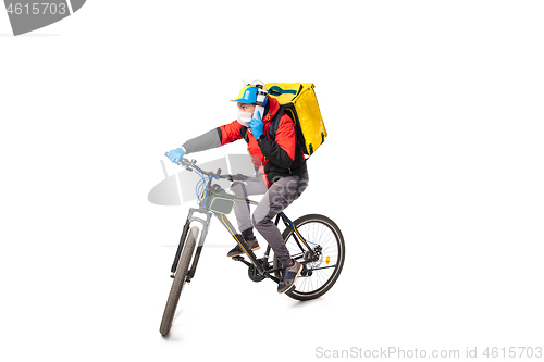 Image of Too much orders. Contacless delivery service during quarantine. Man delivers food and shopping bags during isolation, wearing gloves and face mask.