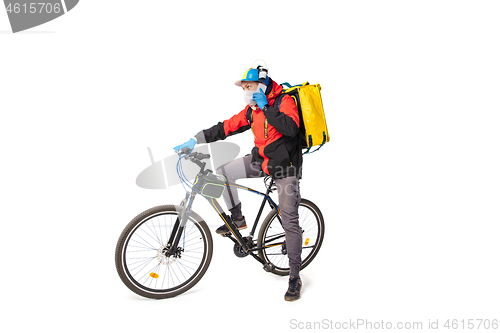 Image of Too much orders. Contacless delivery service during quarantine. Man delivers food and shopping bags during isolation, wearing gloves and face mask.