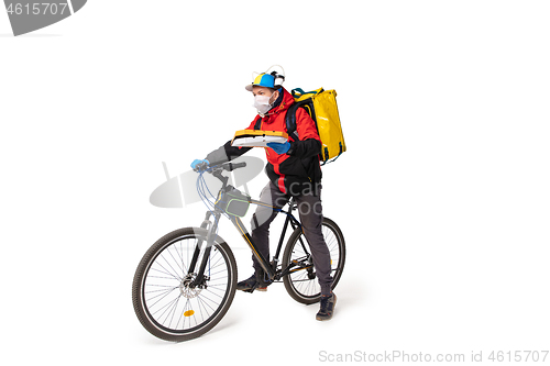 Image of Too much orders. Contacless delivery service during quarantine. Man delivers food and shopping bags during isolation, wearing gloves and face mask.