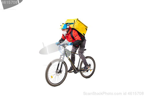 Image of Too much orders. Contacless delivery service during quarantine. Man delivers food and shopping bags during isolation, wearing gloves and face mask.