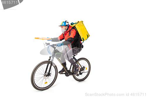 Image of Too much orders. Contacless delivery service during quarantine. Man delivers food and shopping bags during isolation, wearing gloves and face mask.