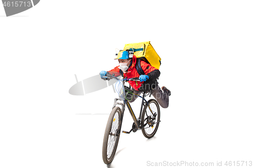 Image of Too much orders. Contacless delivery service during quarantine. Man delivers food and shopping bags during isolation, wearing gloves and face mask.