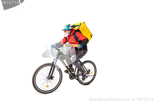 Image of Too much orders. Contacless delivery service during quarantine. Man delivers food and shopping bags during isolation, wearing gloves and face mask.