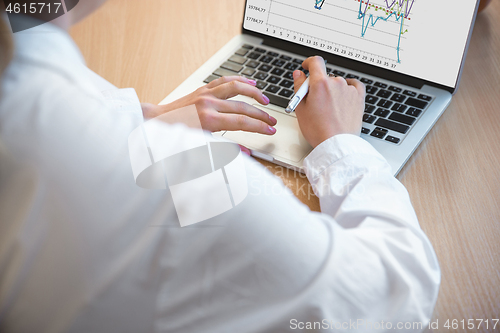 Image of Caucasian entrepreneur, businesswoman, manager working concentrated in office, close up, focus on hands