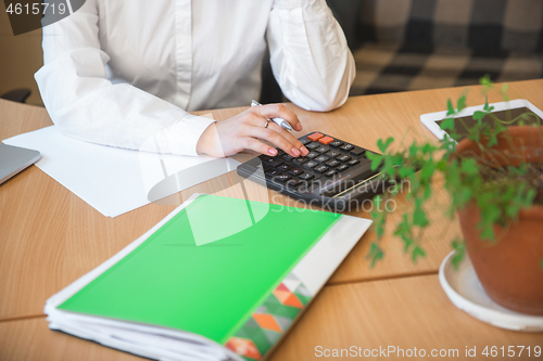 Image of Caucasian entrepreneur, businesswoman, manager working concentrated in office, close up, focus on hands