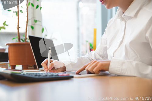 Image of Caucasian entrepreneur, businesswoman, manager working concentrated in office, close up, focus on hands