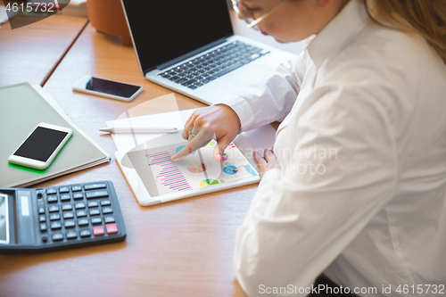 Image of Caucasian entrepreneur, businesswoman, manager working concentrated in office, close up, focus on hands